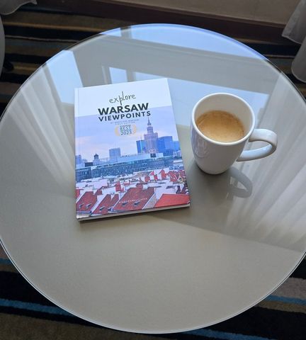 The book on a glass table next to a coffee